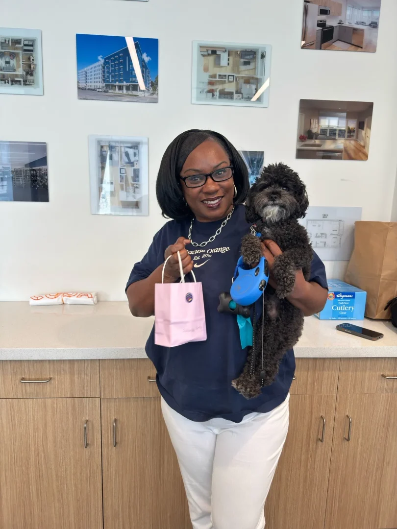 woman holding dog at pet friendly apartments in syracuse ny